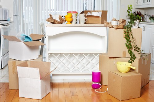 Flat removals in Wandsworth with moving boxes in an apartment hallway